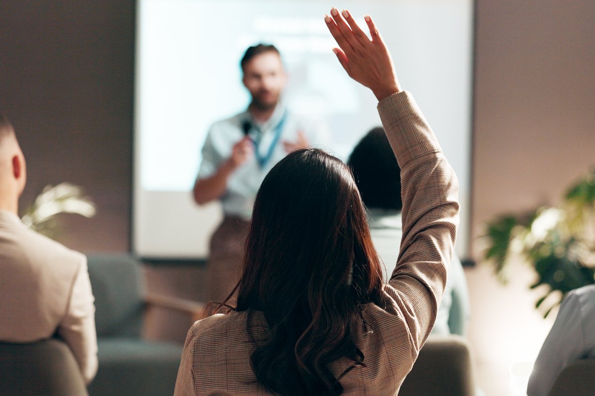 An attendee raising a hand during a training session