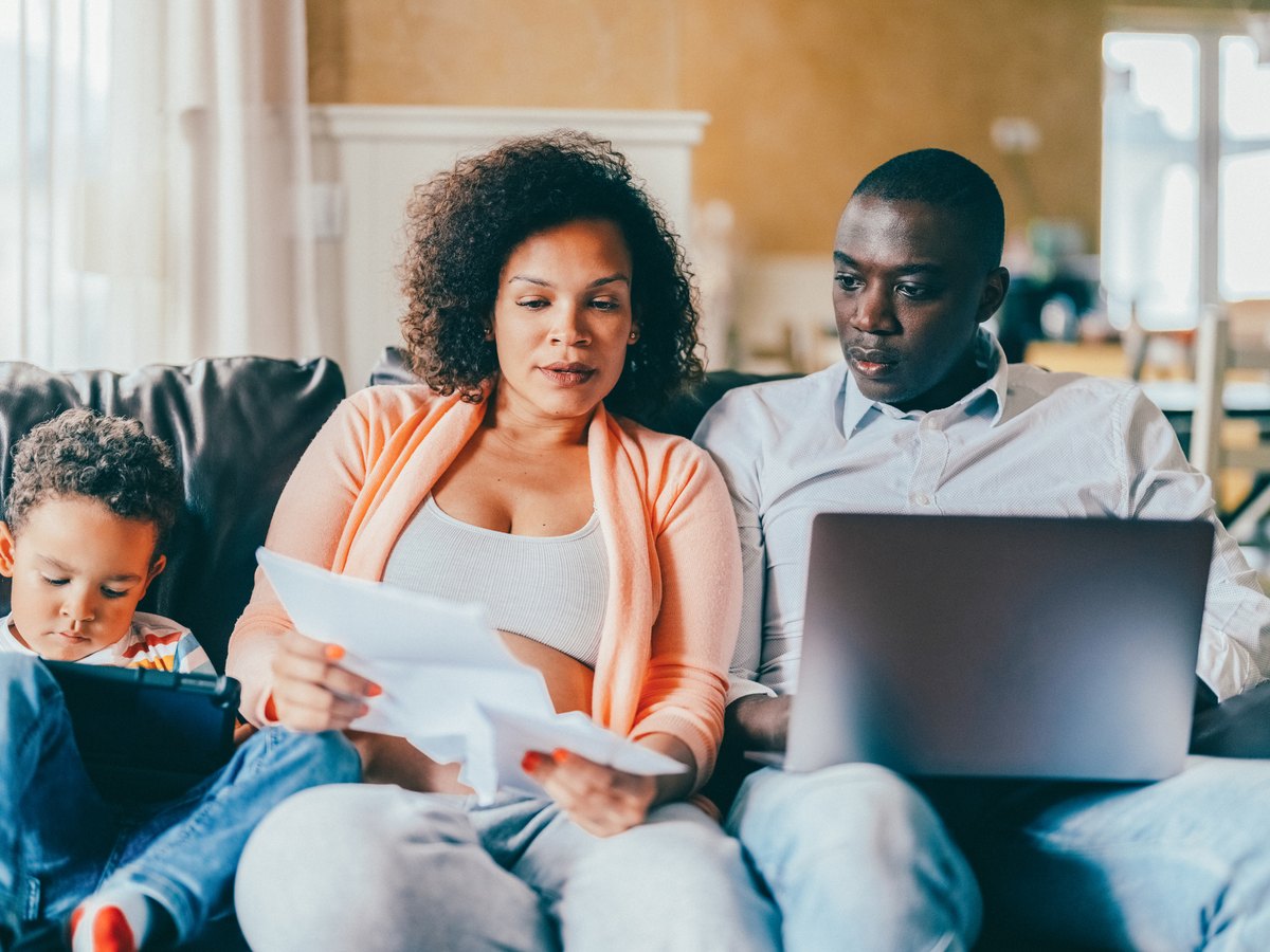 A family reviewing benefits paperwork together at home