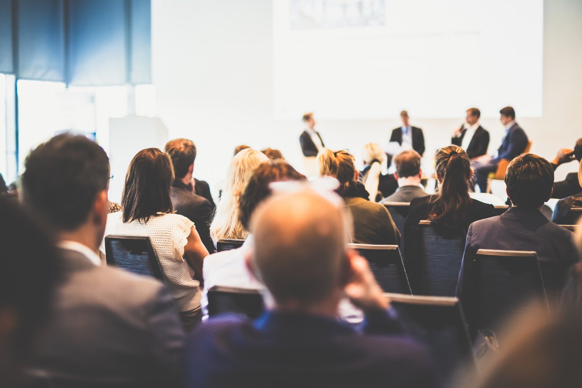 A seated audience at a large training session