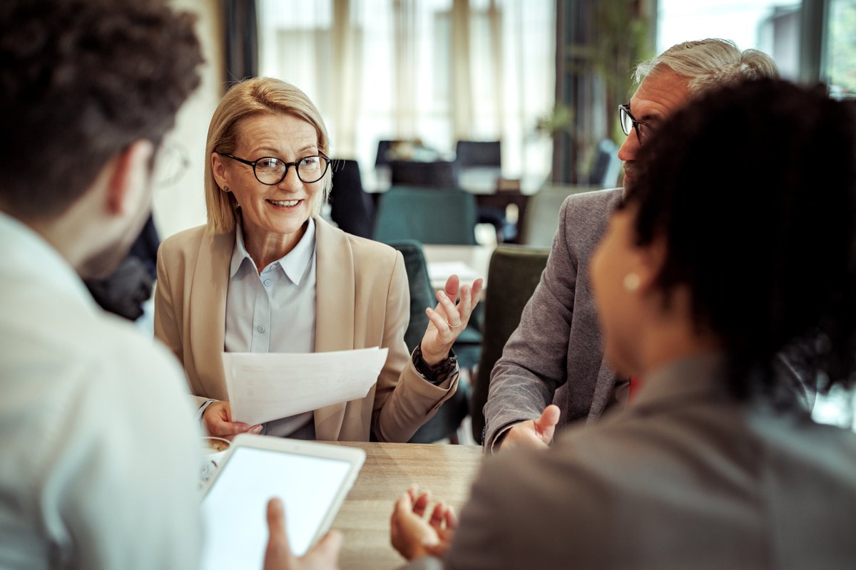 Colleagues in discussion around a conference table